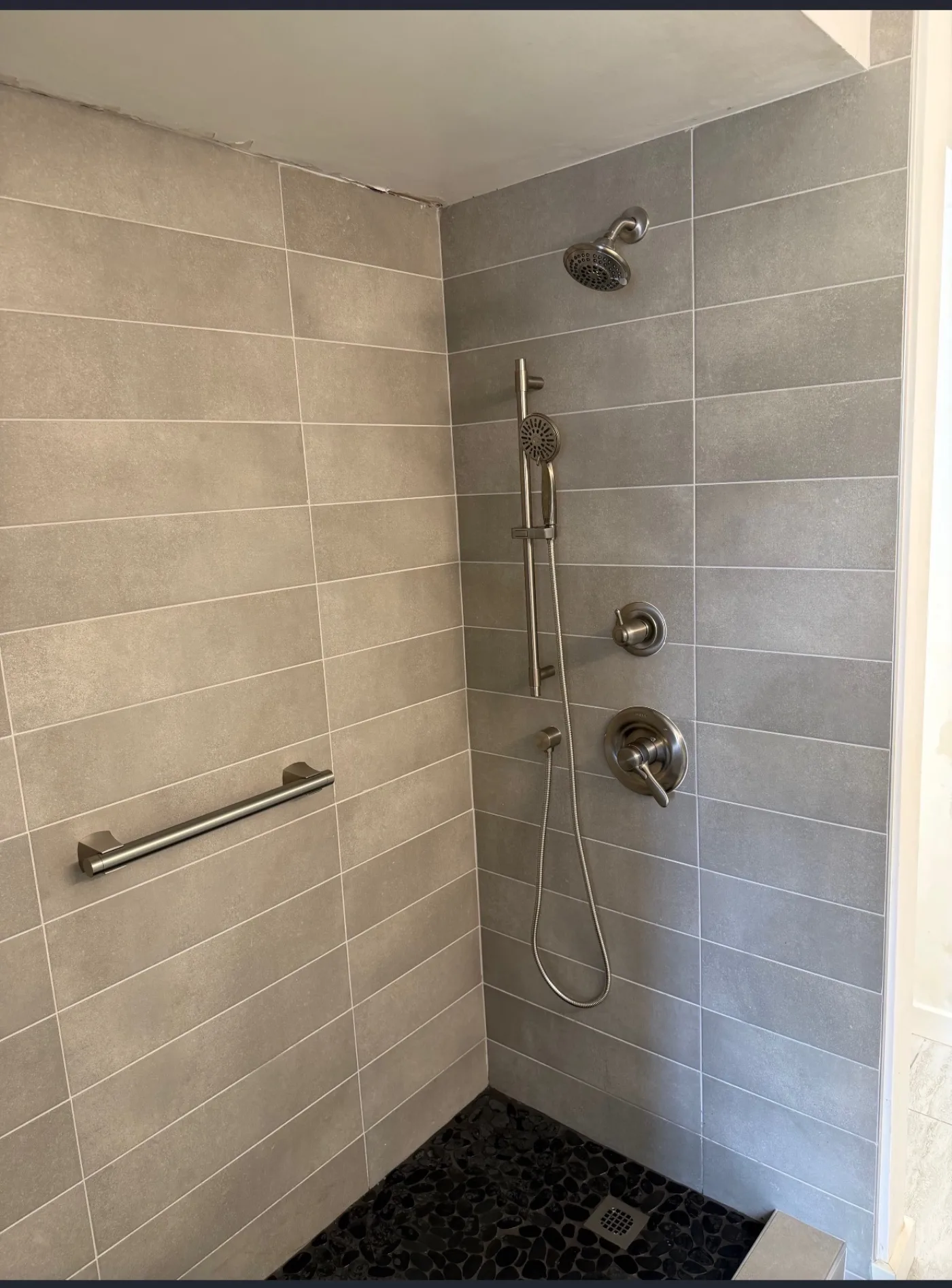 Finished tiled walk-in shower with brushed-nickel fixtures in Honolulu, HI